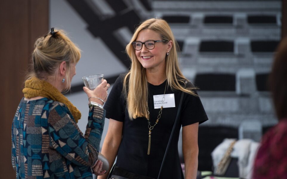 Two people are talking and smiling