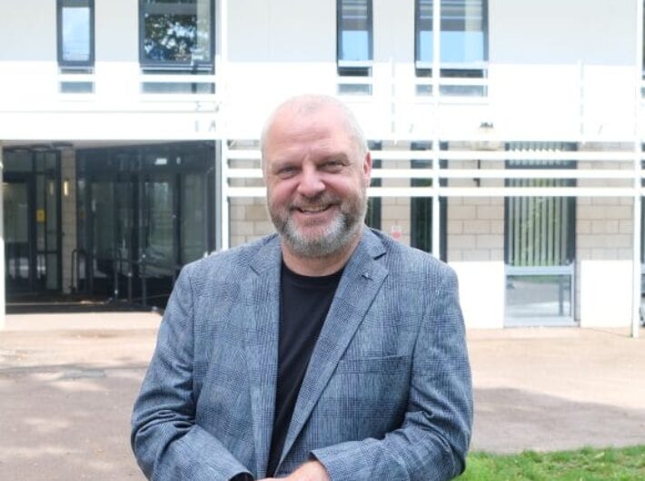 Bald man smiling at camera
