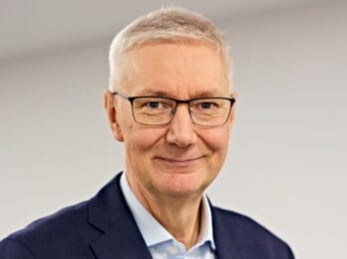 Man with glasses smiling